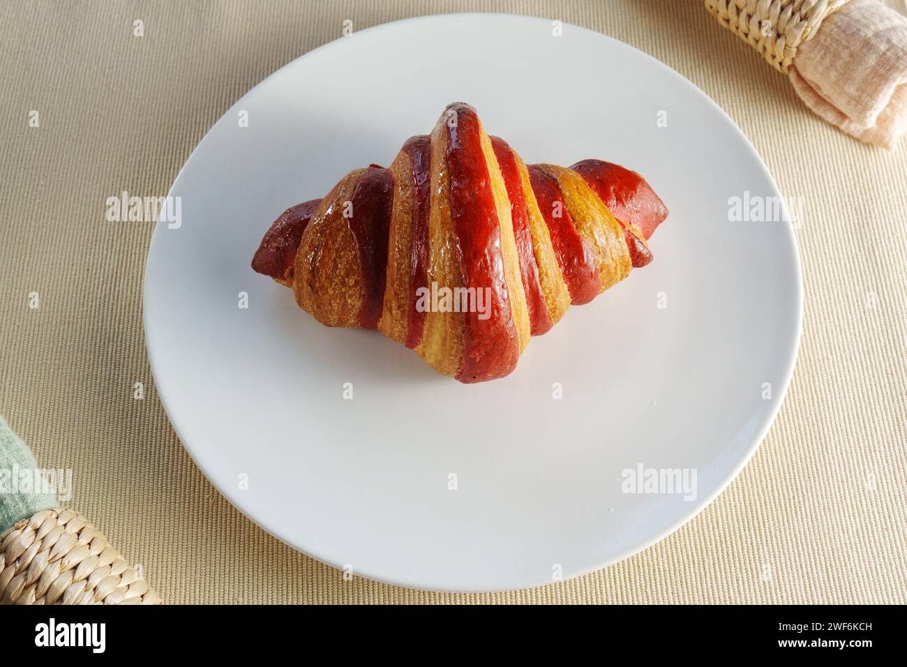 White Porcelain Platter, Adorned With a Juicy Croissant Crimson Strawberry. Stock Photo