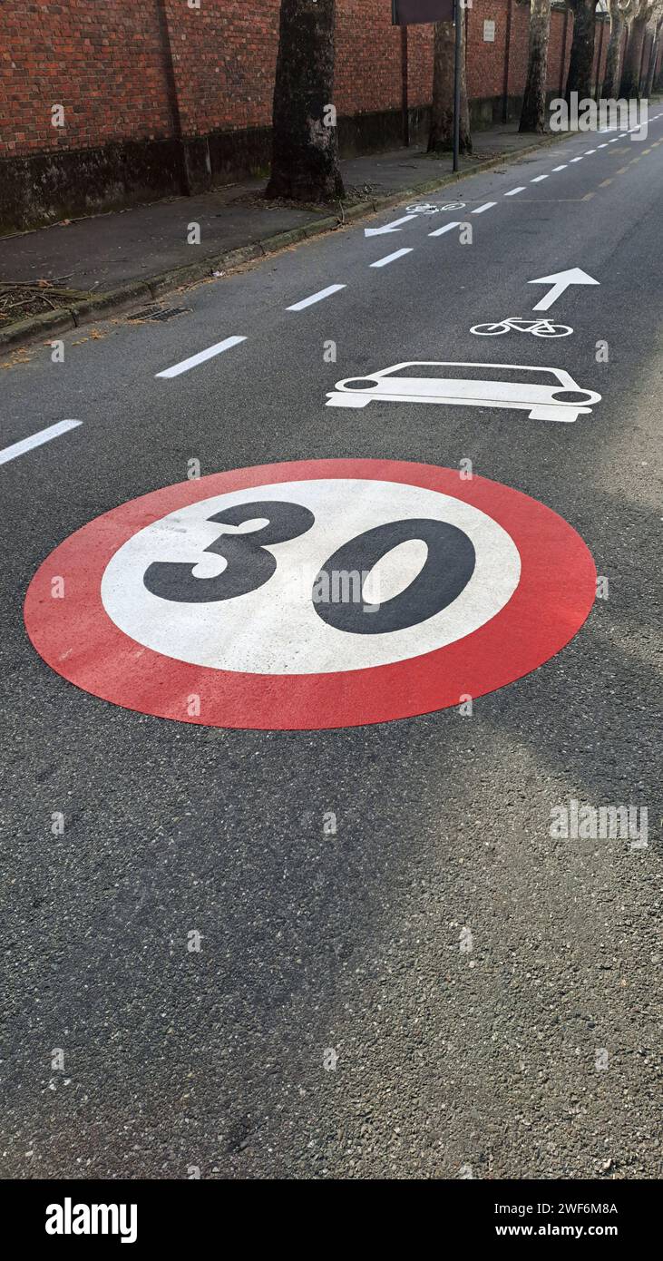 Milan, Italy, 01.28.2024: City street with speed limit sign 30 km/h Stock Photo