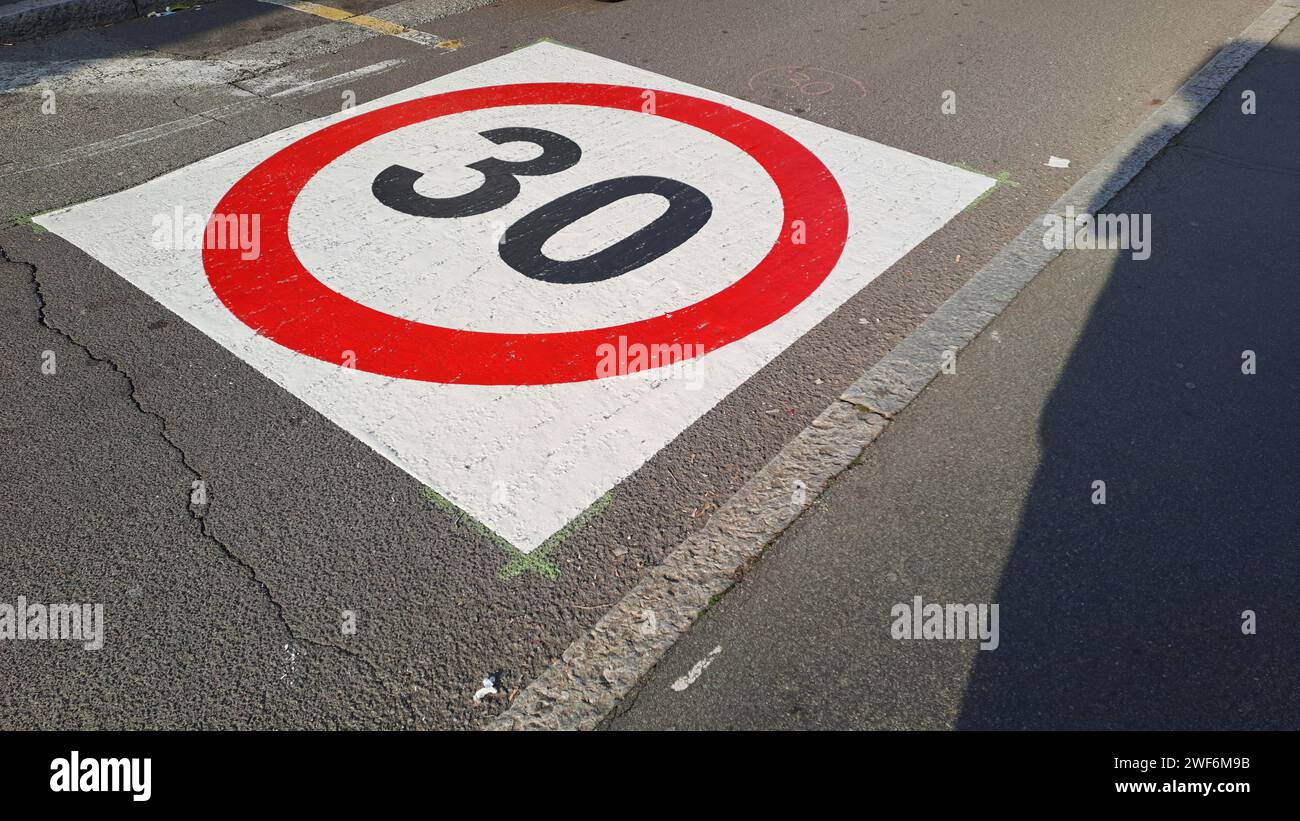 Milan, Italy, 01.28.2024: City street with speed limit sign 30 km/h Stock Photo