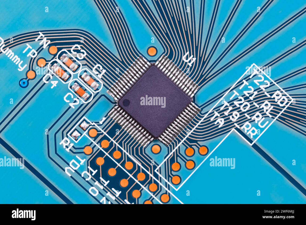 Microprocessor on a blue printed circuit board close-up, top view. Macro photography Stock Photo