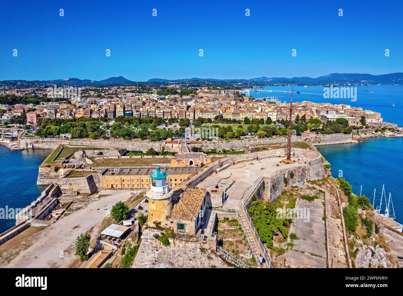 Panoramic view of the Old Town of Corfu with the lighthouse of the Old Fortress in the foreground. Corfu island, Ionian Sea, Greece. Stock Photo