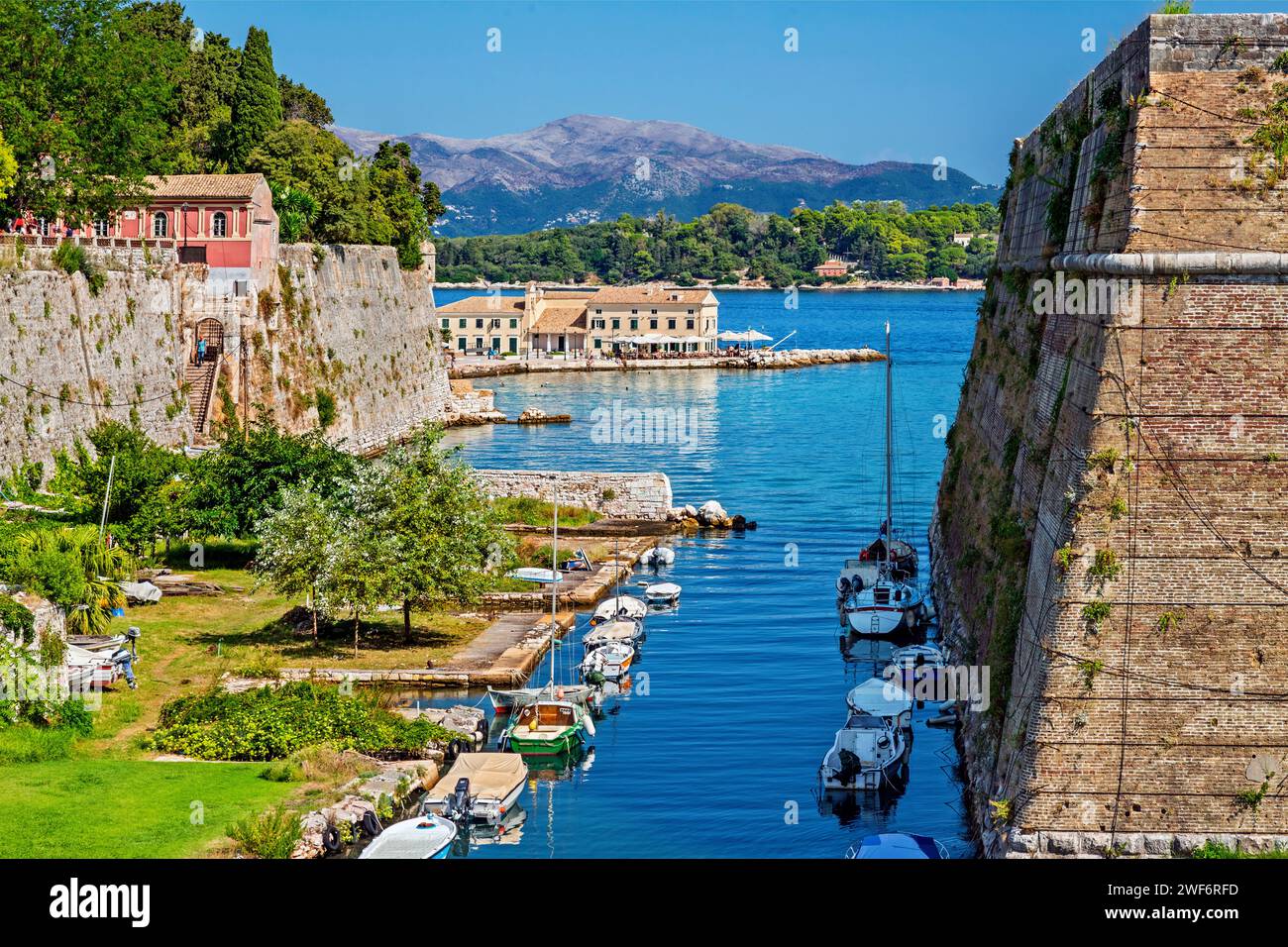 Greece, Corfu (or 'Kerkyra') island. The canal called 'Contrafossa', that separates the Old Fort from the old town. in the background, Faliraki beach. Stock Photo