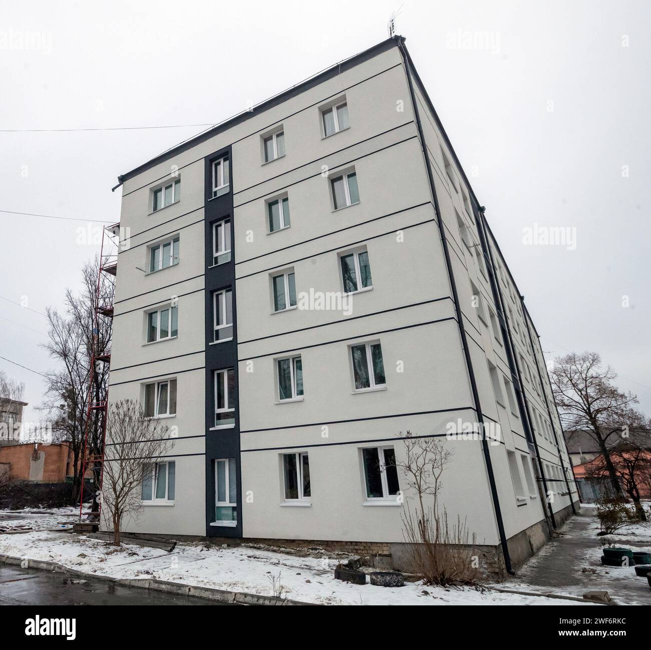 BUCHA, UKRAINE - JANUARY 24, 2024 - The restored facade of one of the buildings repaired after the de-occupation of Bucha, Kyiv region, north-central Ukraine. Stock Photo