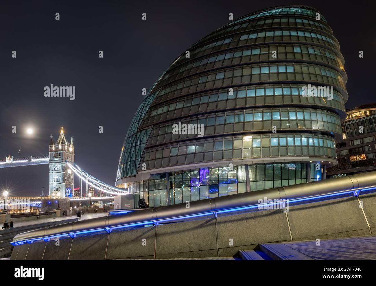 London. UK-01.27.2024. A night time view of City Hall with Tower Bridge in the background. The London mayor's office and administrative building. Stock Photo