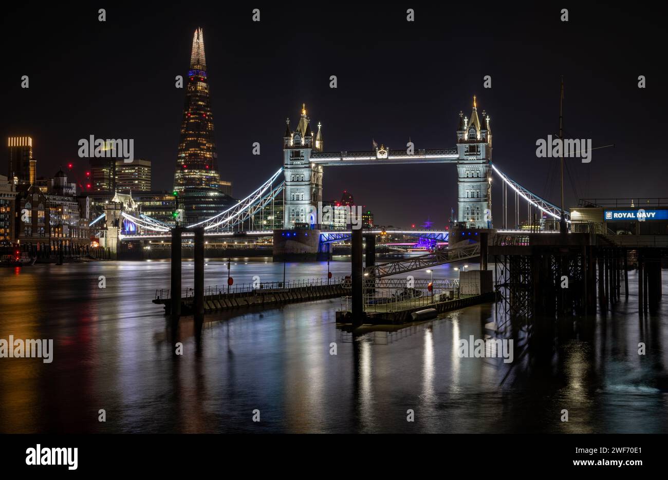 London. UK-01.27.2024. A general view of the Thames River city sky line with Tower Bridge, City Hall and The Shard in colourful light casting beautifu Stock Photo