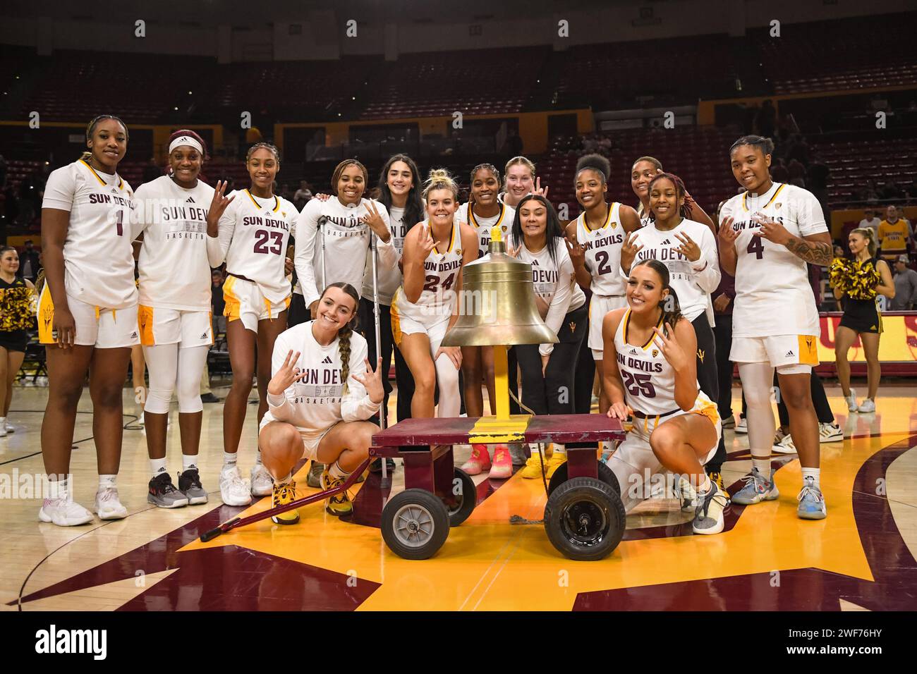 Arizona State Sun Devils pose with the victory bell after an NCAA basketball game between the Arizona State Sun Devils and Cal Golden Bears in Tempe, Stock Photo