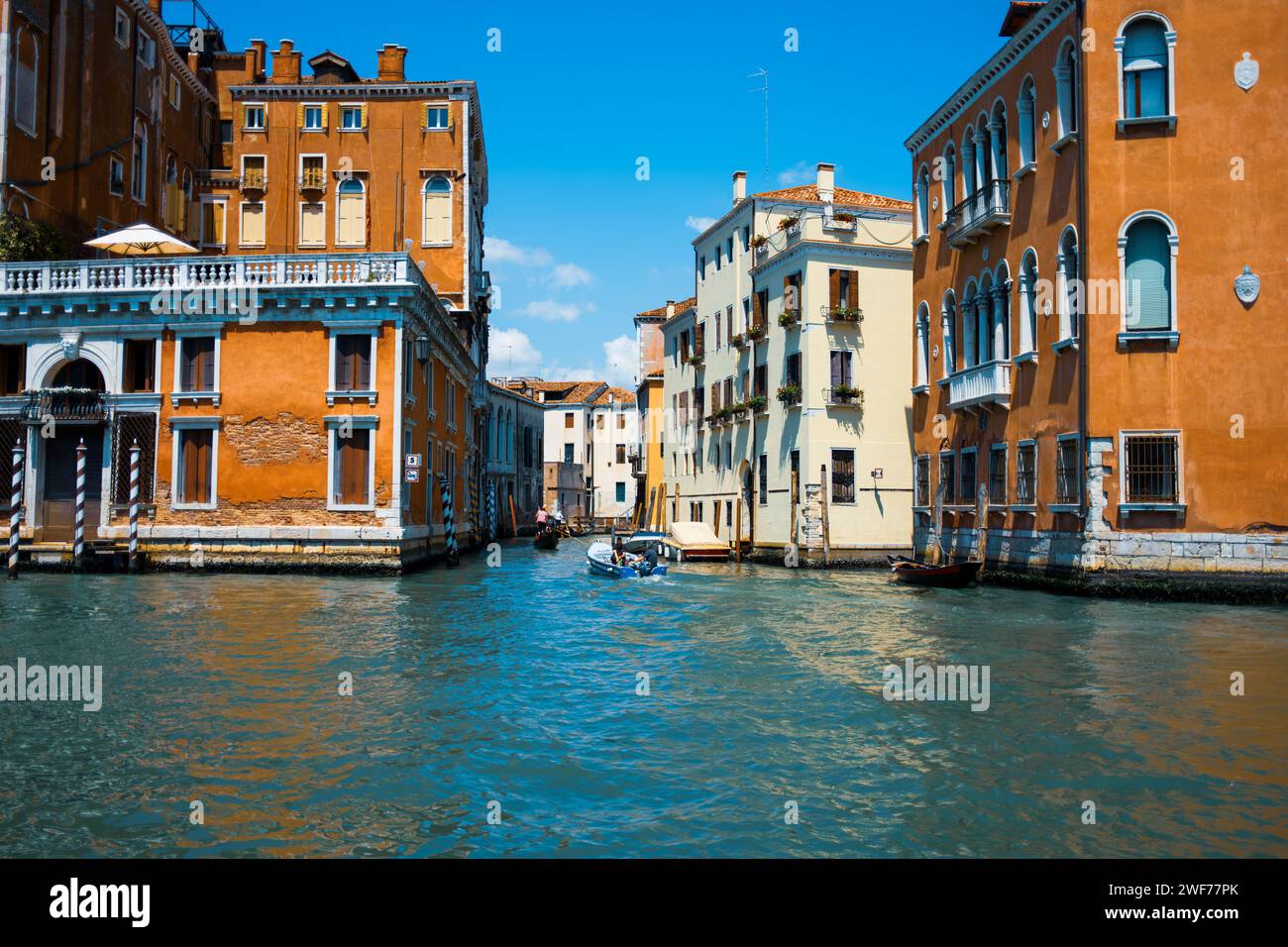 The vibrant waterways of Venice, where colorful buildings line the canals, reflecting the city's rich cultural tapestry and maritime legacy. Stock Photo