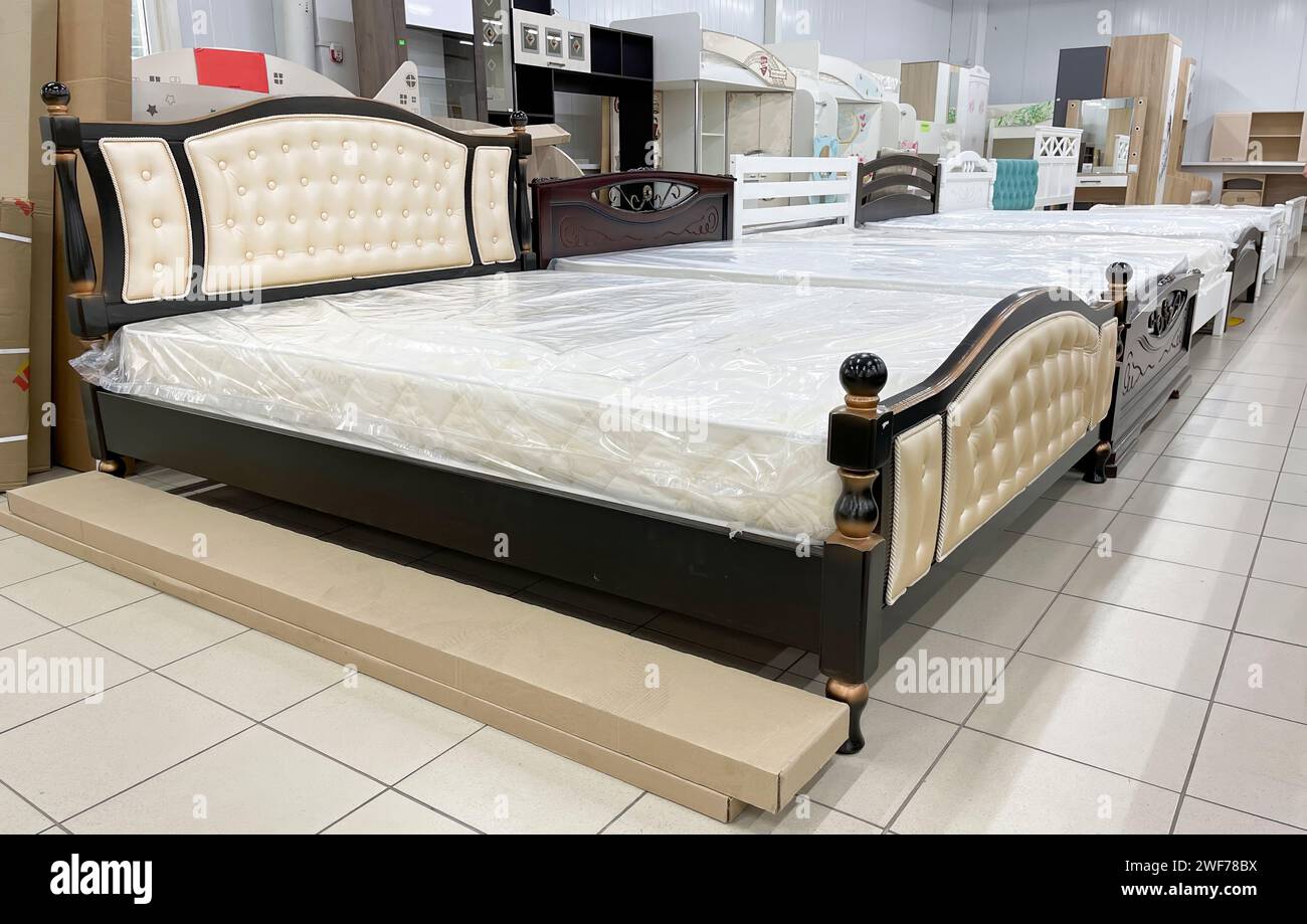 Luxury wooden beds for sale at furniture store Stock Photo Alamy