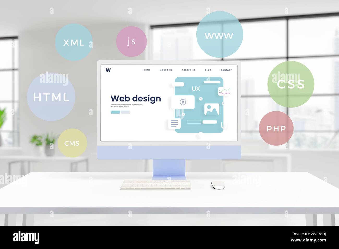 Computer display showcases a conceptual web design studio page with layout elements. Floating balloons feature HTML, PHP, CSS, XML, JS, CMS technologi Stock Photo