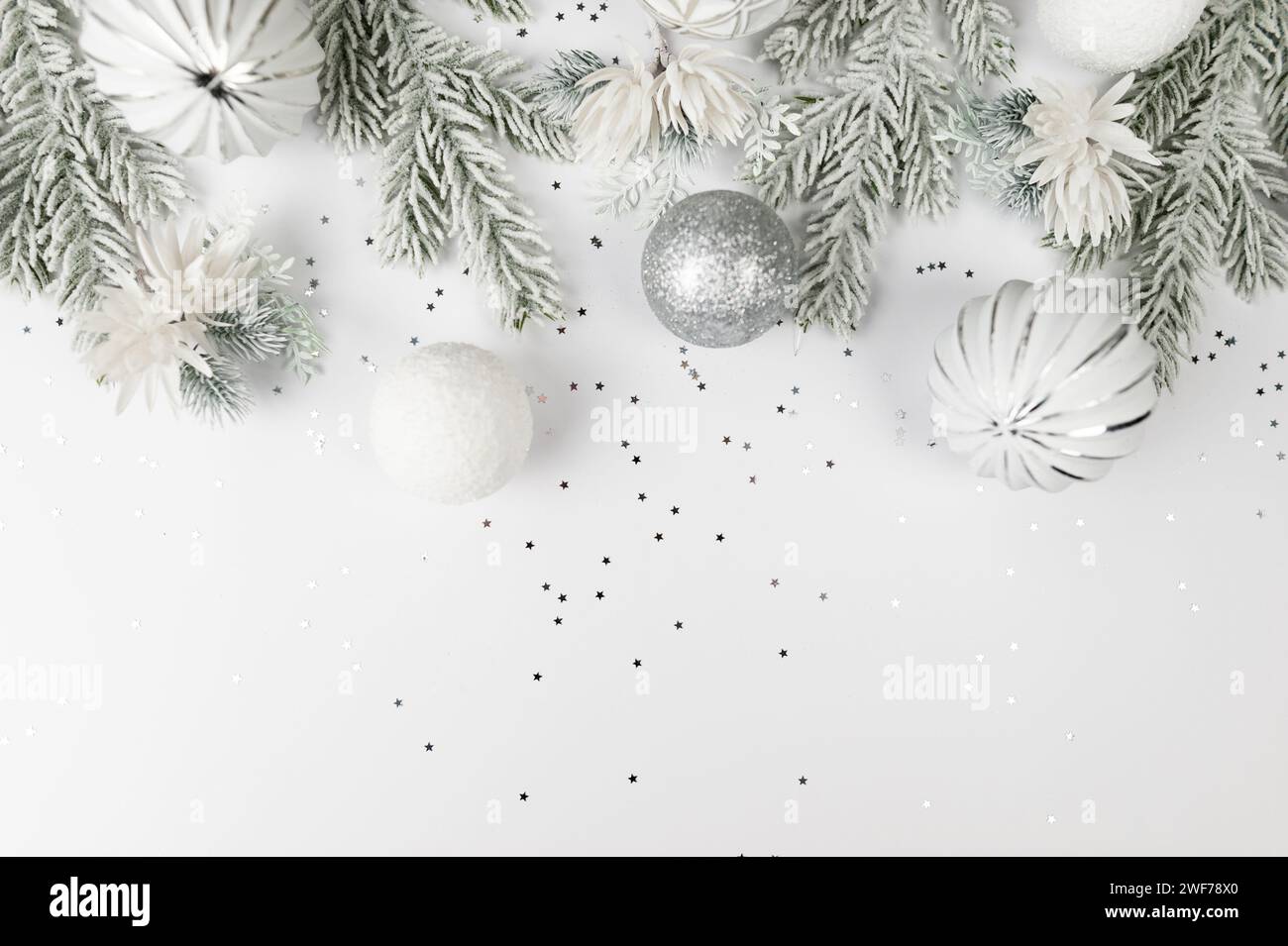 Christmas composition, white and silver decorations, fir tree branches ...
