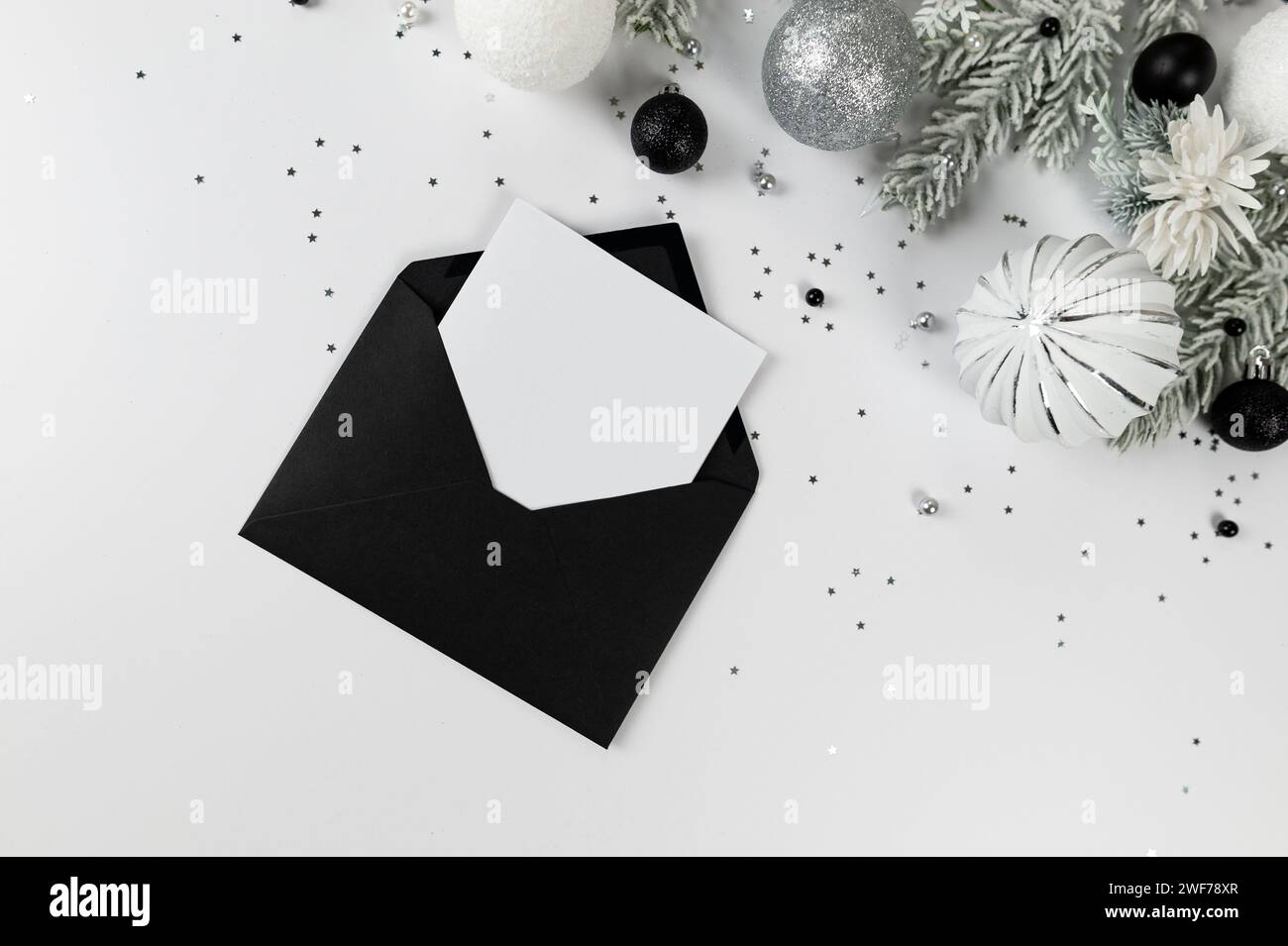 Christmas composition, black envelope, white and silver decorations ...