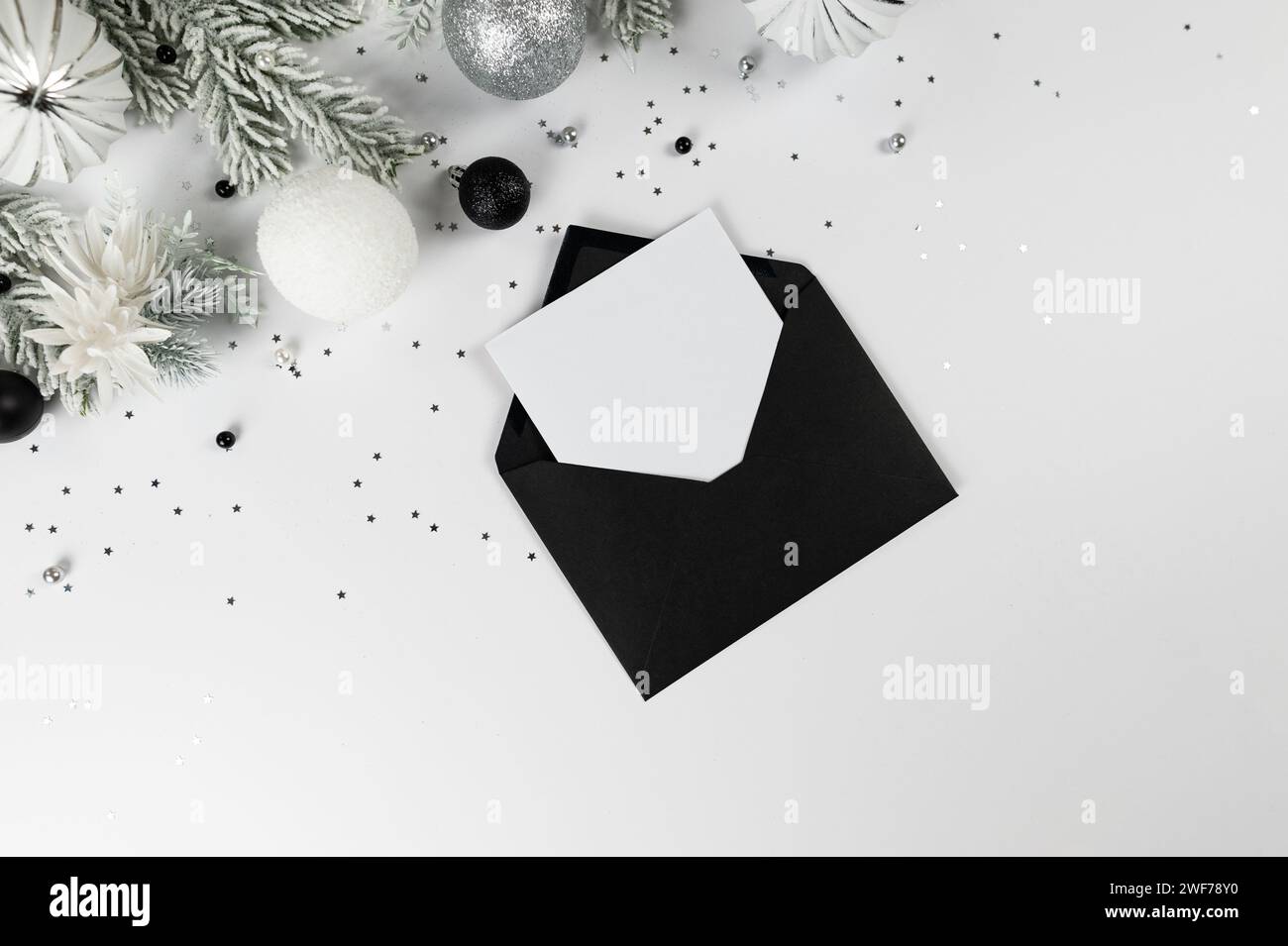 Christmas composition, black envelope, white and silver decorations ...