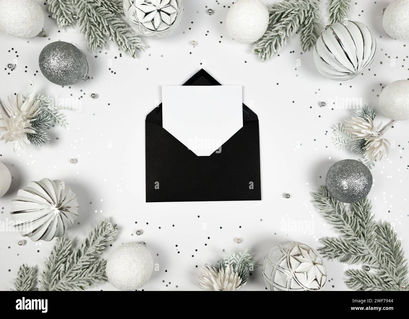 Christmas composition, black envelope, white and silver decorations ...