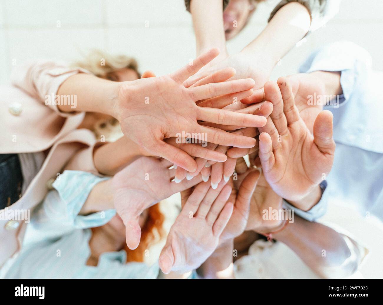 Business people stacking their hands to show unity and support. Business and teamwork concept. Stock Photo
