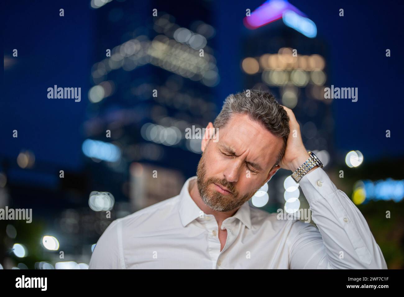 Close up portrait of stressed business man on night city background ...