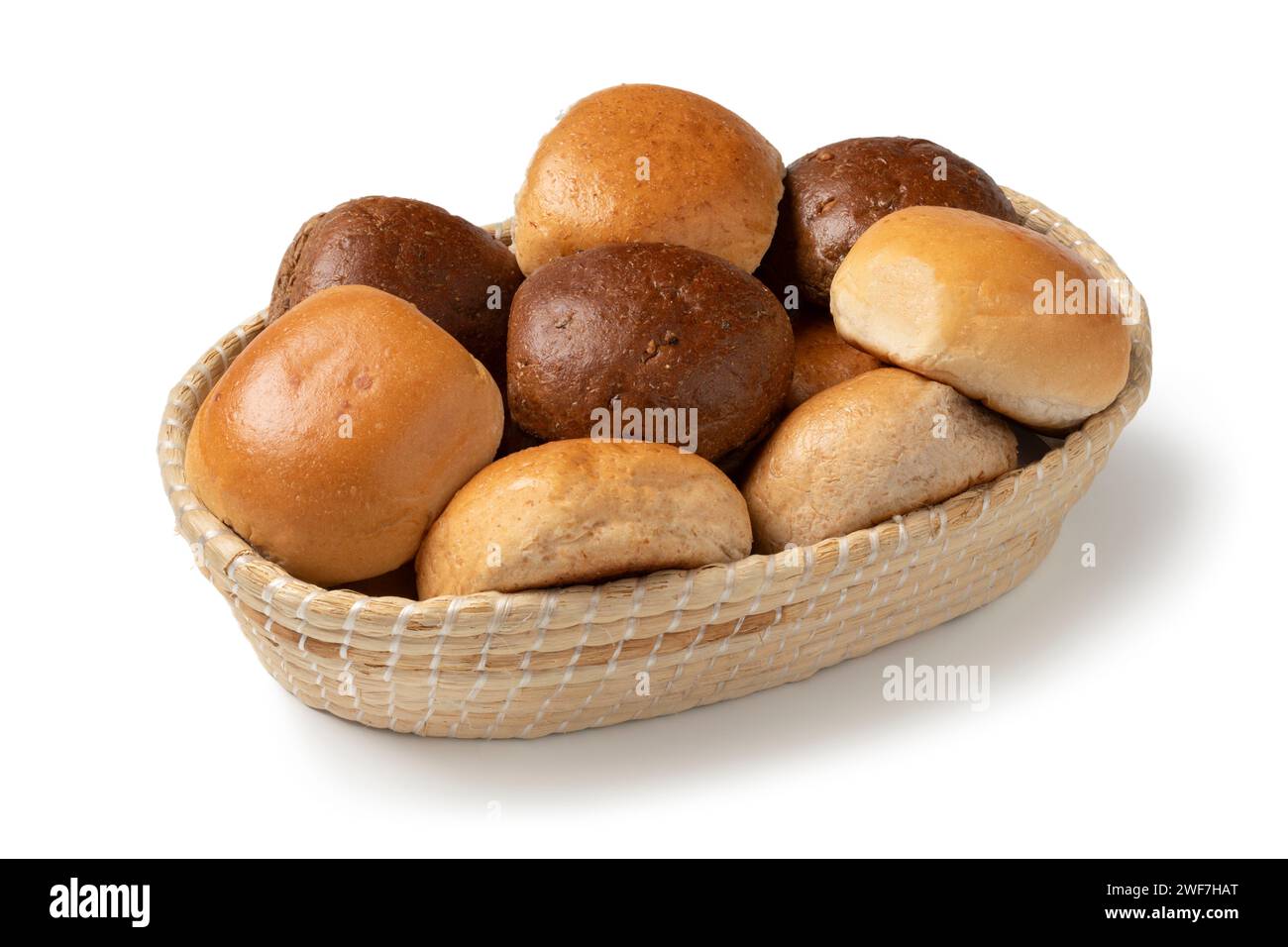 Basket with a variation of fresh baked white and brown buns of bread close up isolated on white background Stock Photo