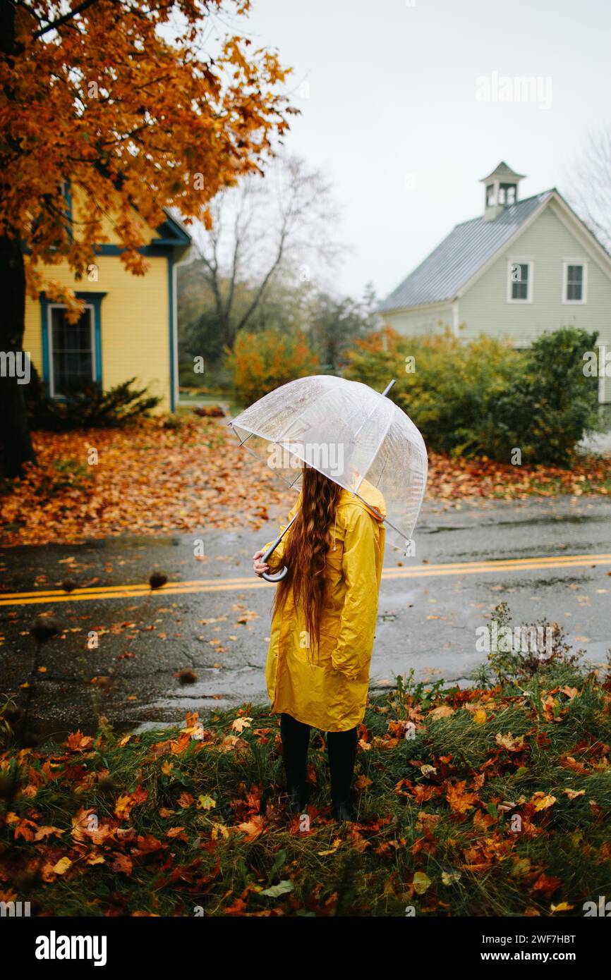 Woman watched the rainy road in Autumn Stock Photo