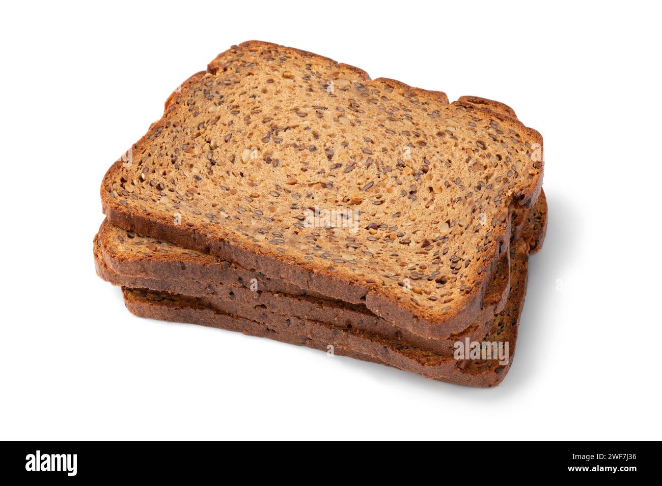 Thin slices of fresh baked brown flaxseed bread close up isolated on white background Stock Photo