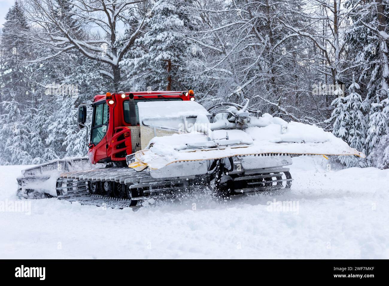 Snow groomer snowcat ratrack machine preparing ski slope for alpine skiing, winter resort Bansko, Bulgaria Stock Photo