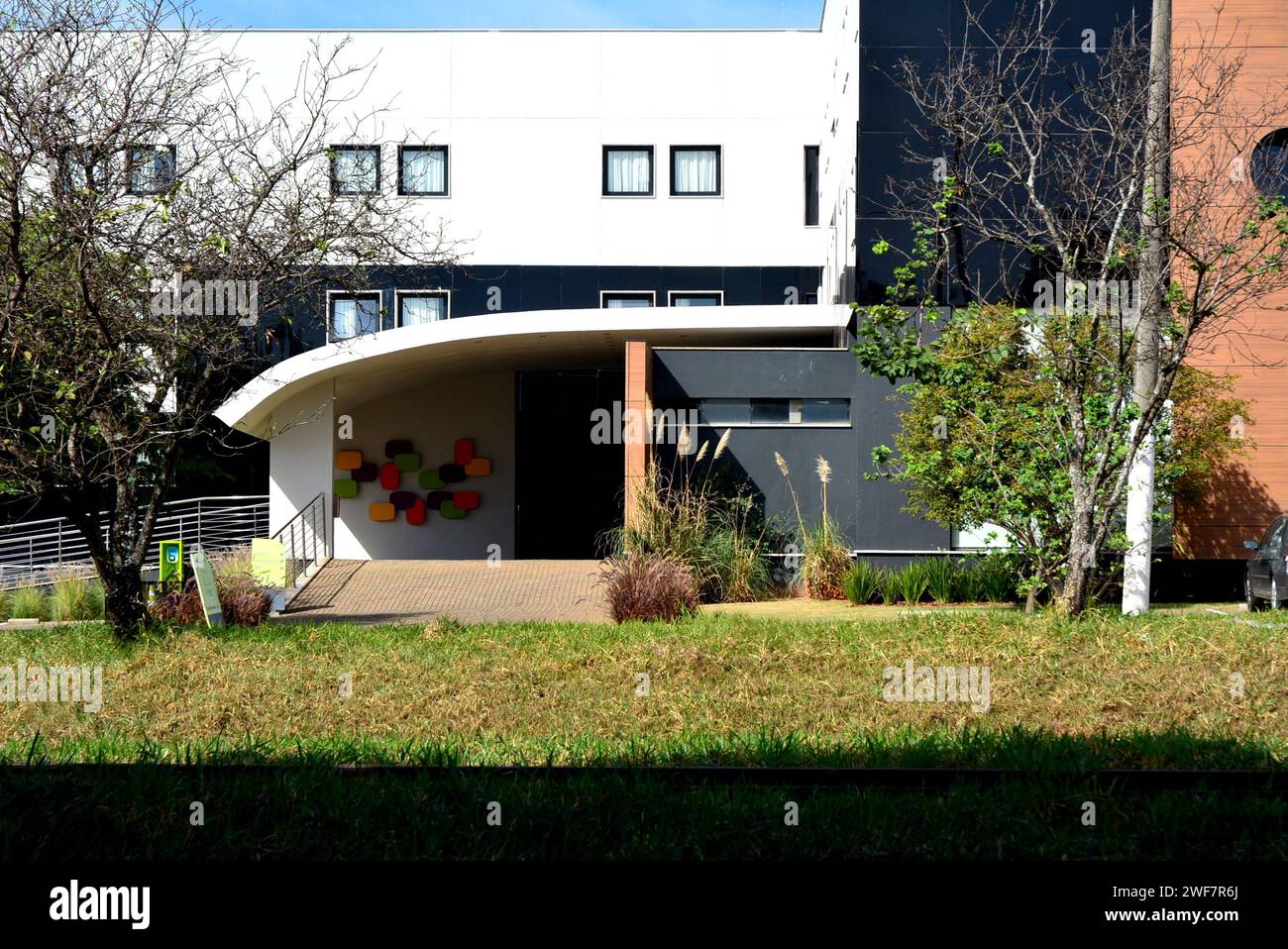 Architecture, hotel facade in Brazil, South America. Front lawn. Colored walls. zoom Stock Photo