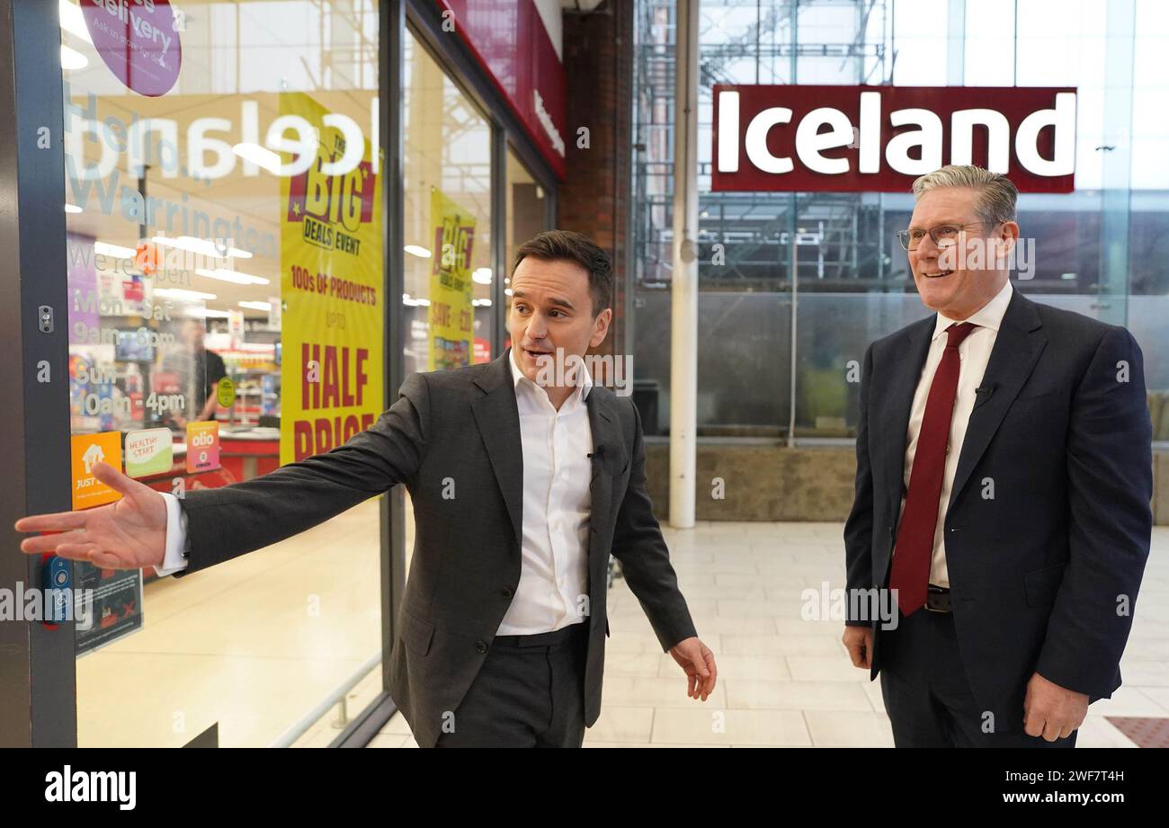 Labour leader Sir Keir Starmer (right) with executive chairman of Iceland supermarket, Richard Walker, during a visit to an Iceland store in Warrington. Mr Walker has given his backing to Labour, saying the party was the 'right choice' for business and voters. Picture date: Monday January 29, 2024. Stock Photo