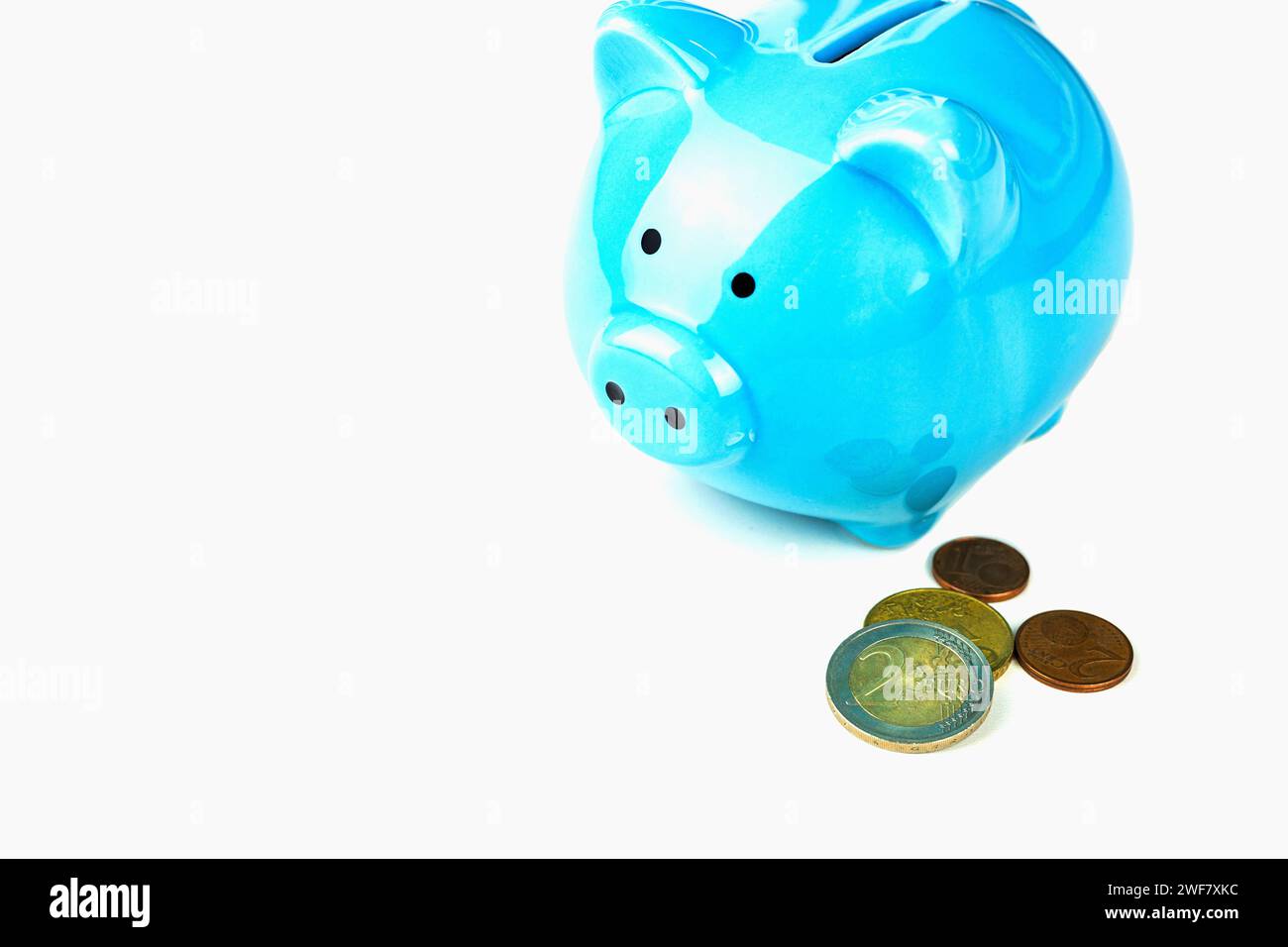 A piggy bank with coins highlighted on a white background Stock Photo ...