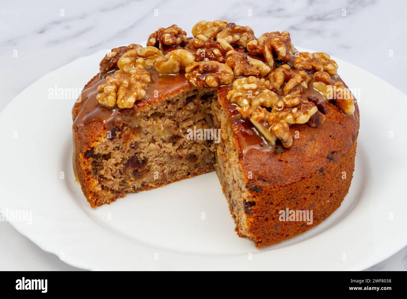 section out of Banana date cake with walnut & honey glaze Stock Photo