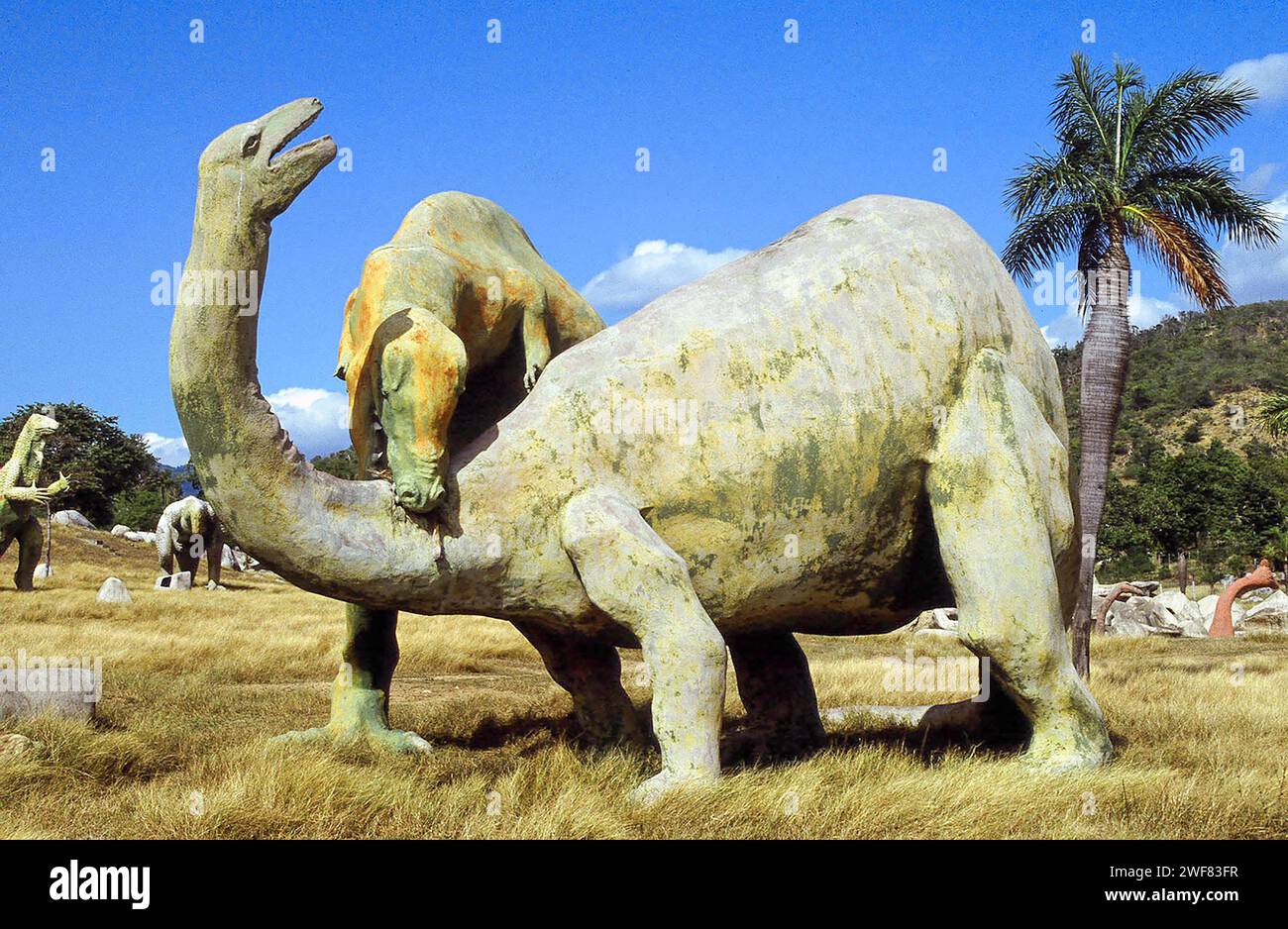 Giant concrete dinosaurs populate a valley in Baconao Park near Santiago de Cuba. Stock Photo
