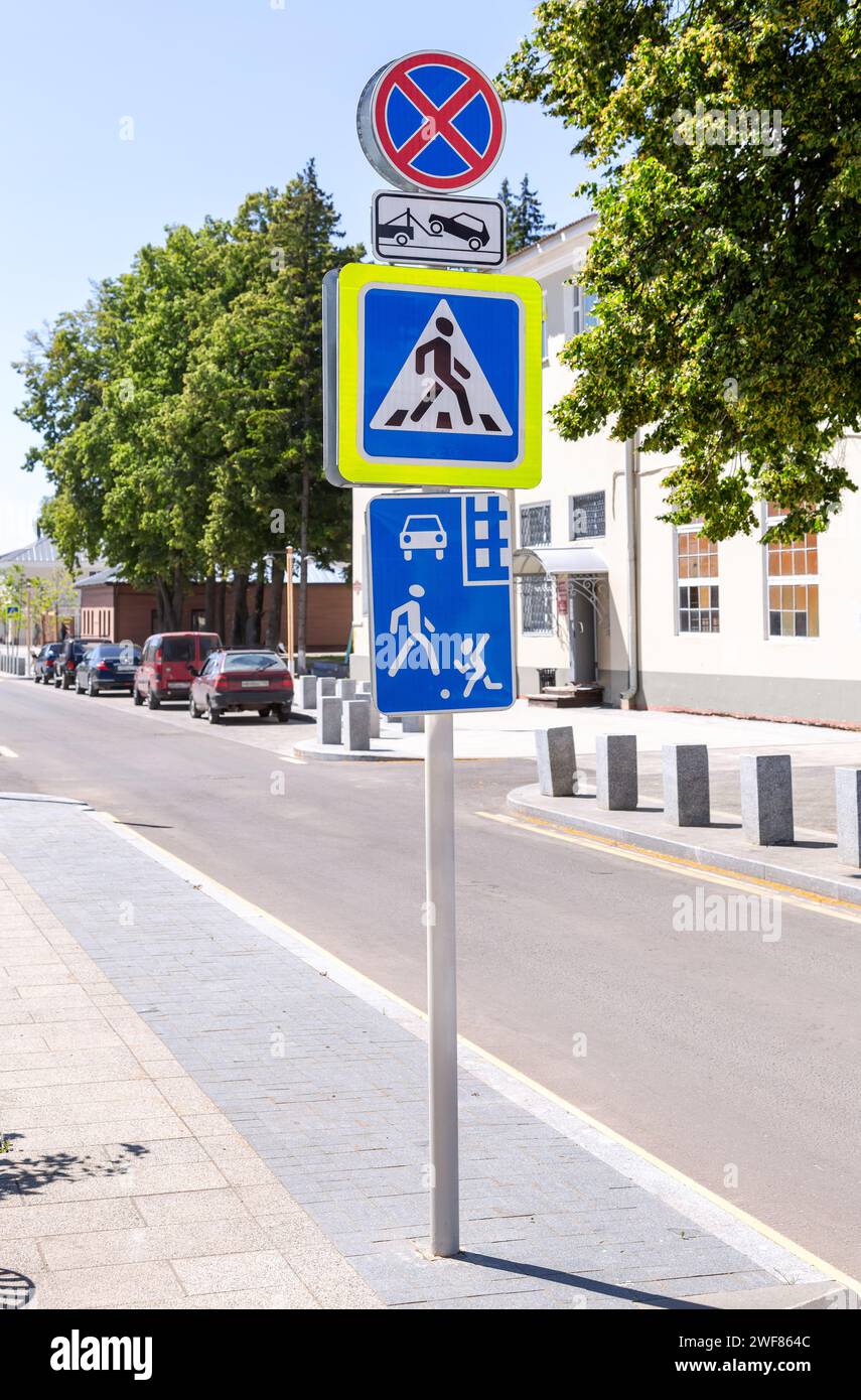 Different road signs on the city street. Pedestrian zone, residential zone, pedestrian crossing Stock Photo