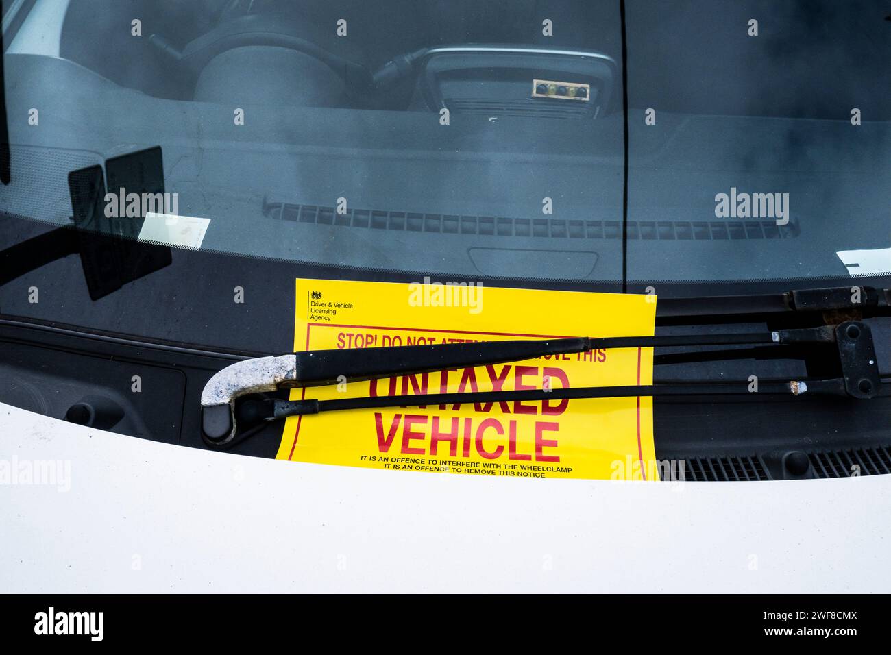 A sign for an untaxed parked vehicle on a windscreen in Newquay in Cornwall in the UK. Stock Photo