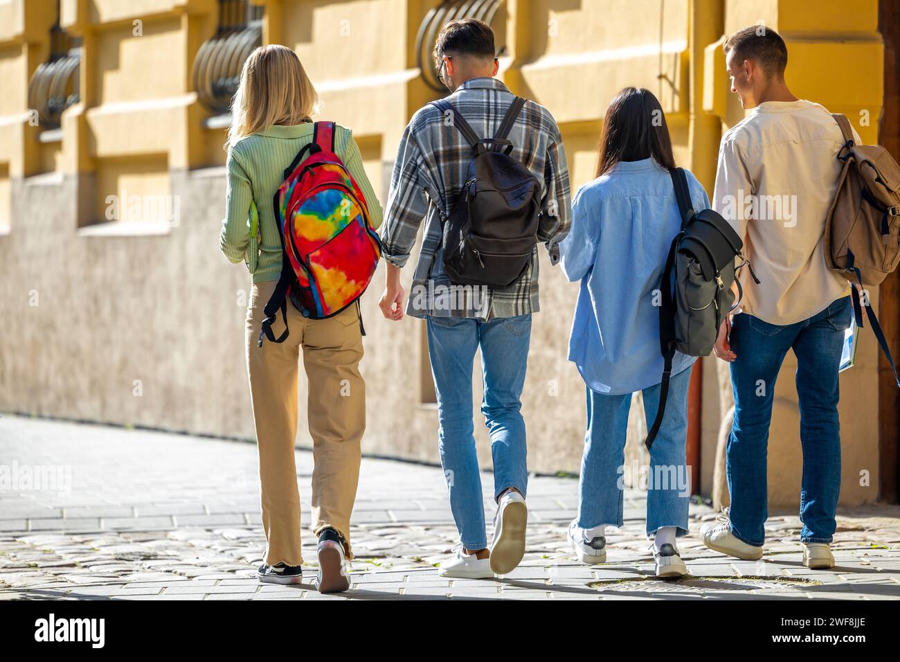 Students with backpacks walking at university campus together Stock ...