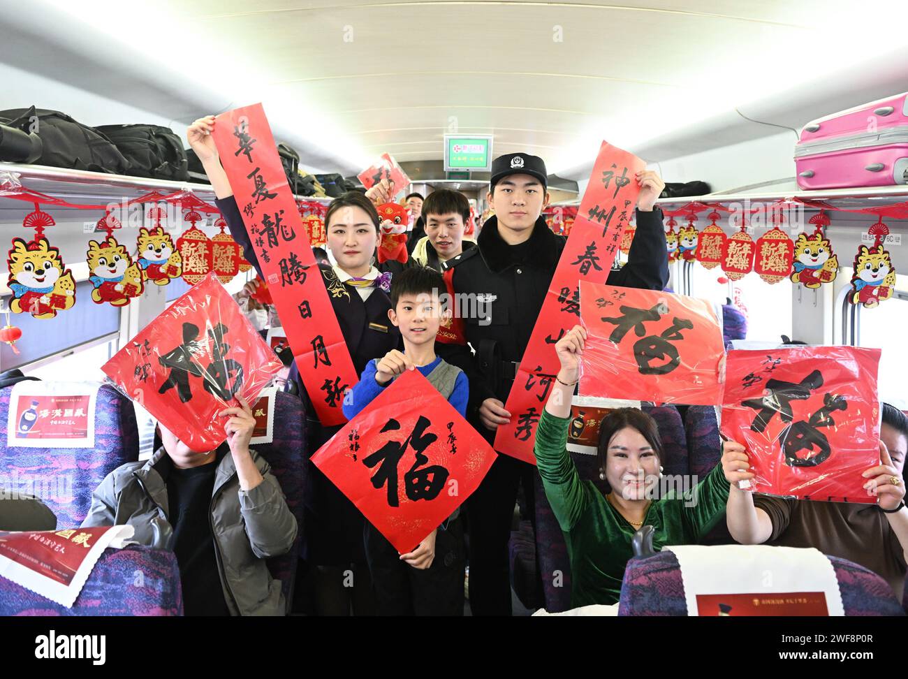 Nanjing 29th Jan 2024 Staff Members And Passengers Pose For A Photo   Nanjing 29th Jan 2024 Staff Members And Passengers Pose For A Photo Onboard G7575 Bullet Train Jan 29 2024 A Series Of Traditional Cultural Activities Such As Opera Performance And Paper Cutting Show Were Held On The Bullet Train On Monday China Officially Ushered In Its Largest Annual Population Migration On Jan 26 The 40 Day Travel Surge Also Known As Chunyun Will See Hundreds Of Millions Of People Return Home And Reunite With Their Friends And Families Credit Ji Chunpengxinhuaalamy Live News 2WF8P0R 