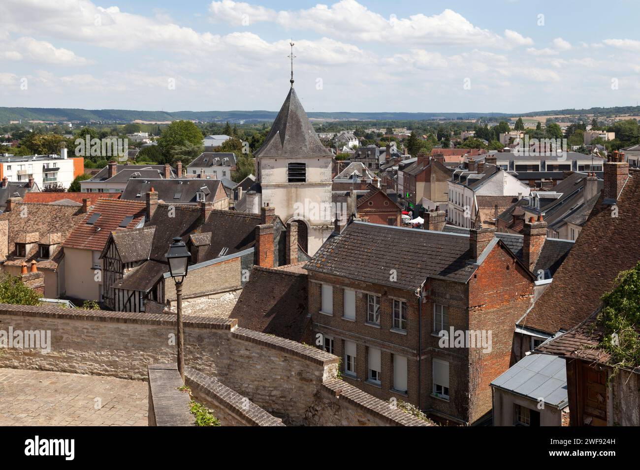 Gaillon, France - August 05 2022: Aerial view of the bell tower of the Saint-Ouen church overlooking the rest of the village. Stock Photo