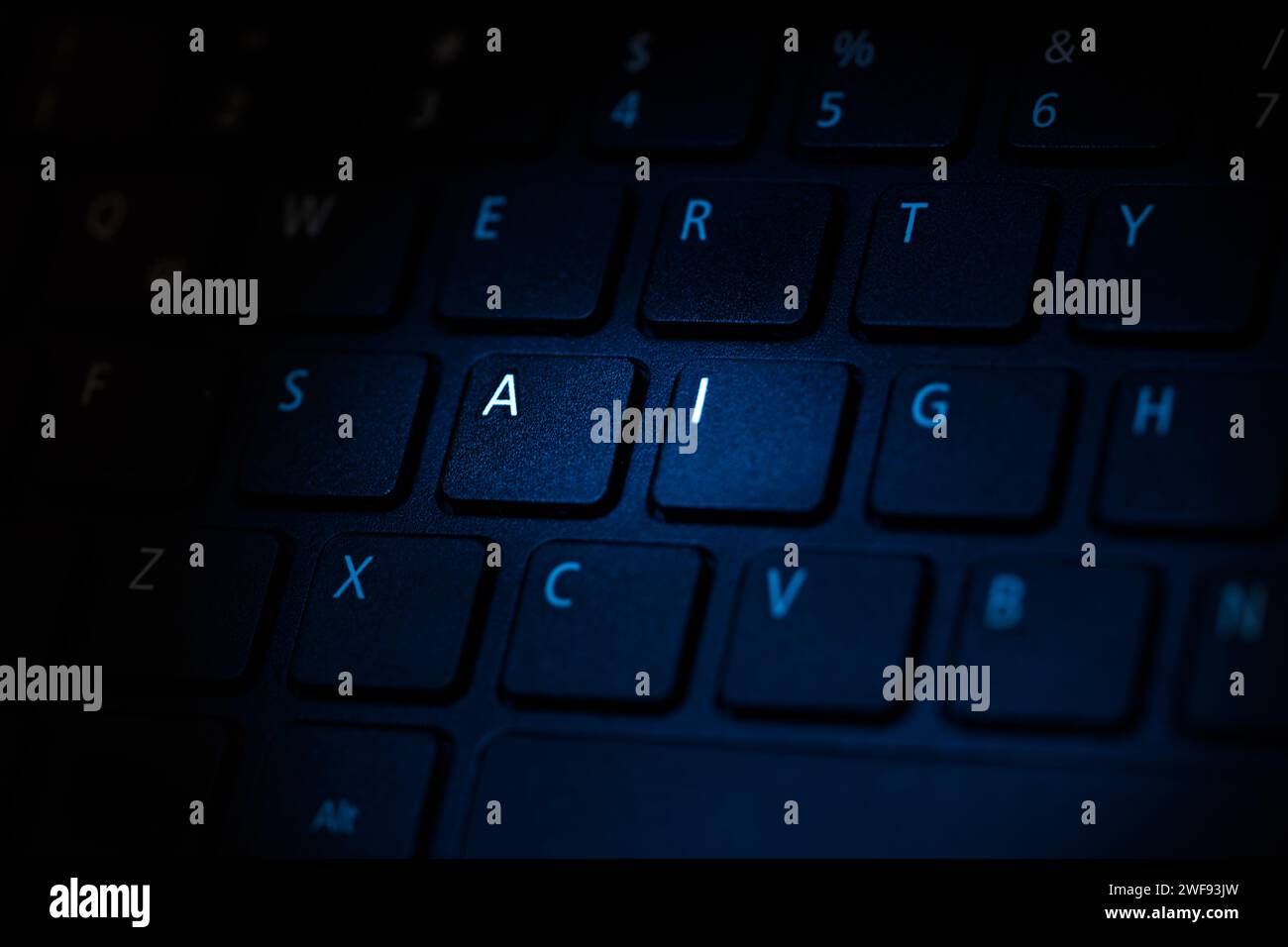 keyboard being illuminated with blue light highlighting letters a i