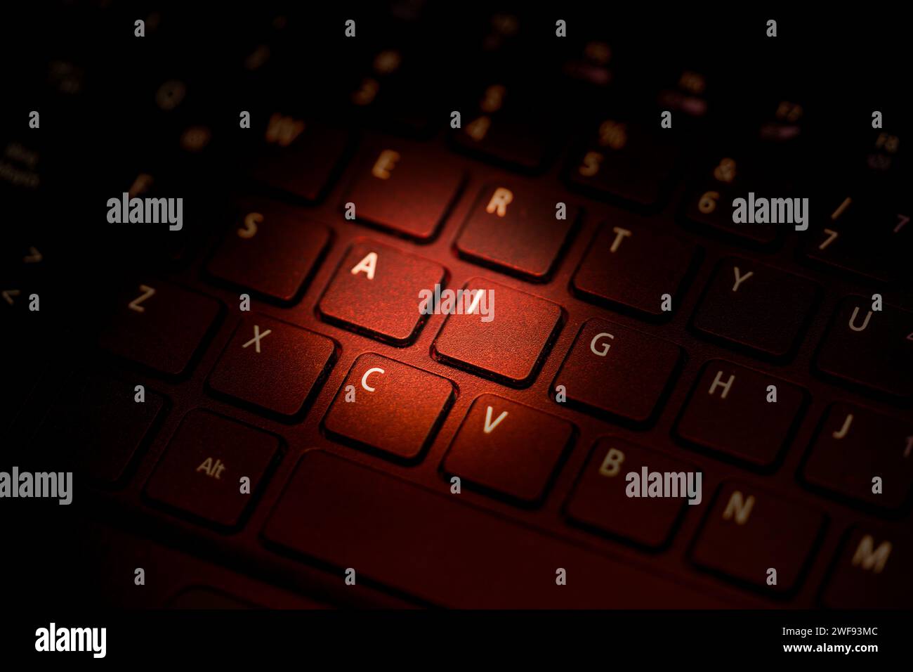keyboard being illuminated with red light highlighting letters a i Stock Photo