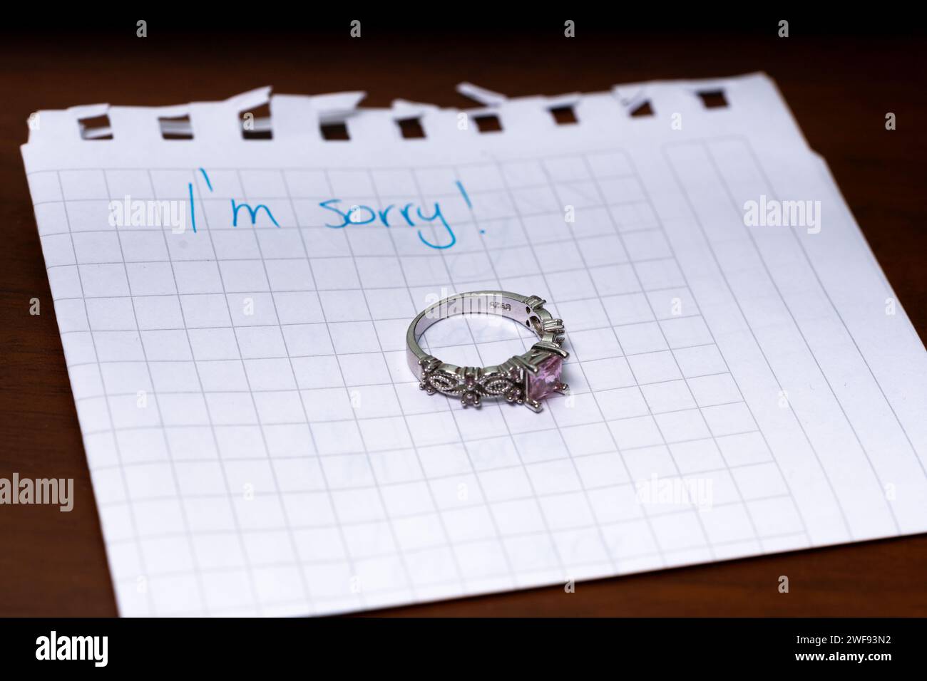 ring left on the night table, i'm sorry message, close up Stock Photo