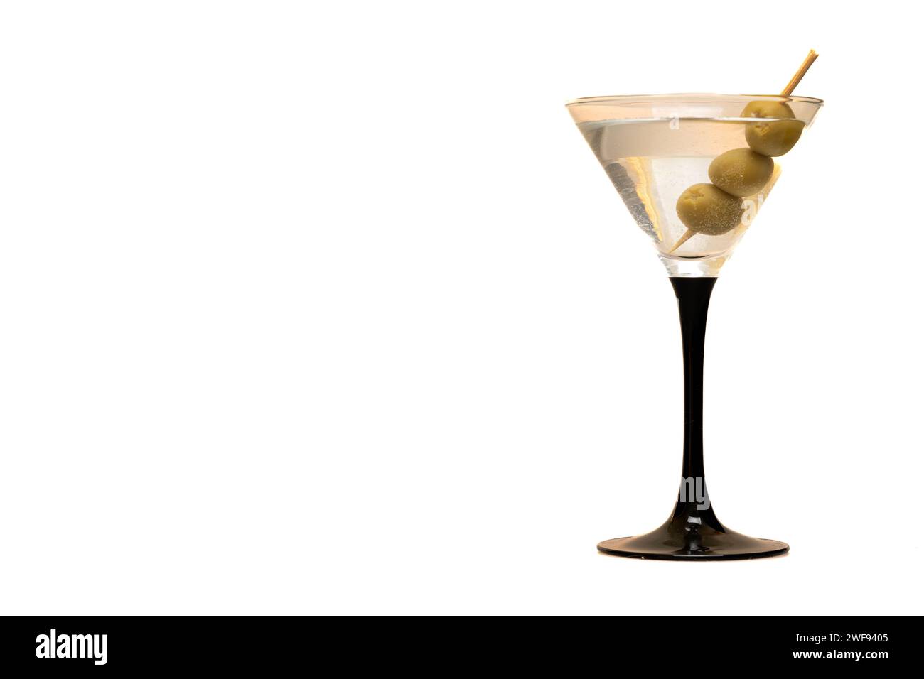 glass of martini with three olives on white background with copy space Stock Photo