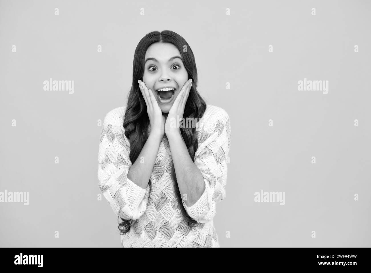 Shocked teenager child with amazed look on yellow background, amazement ...