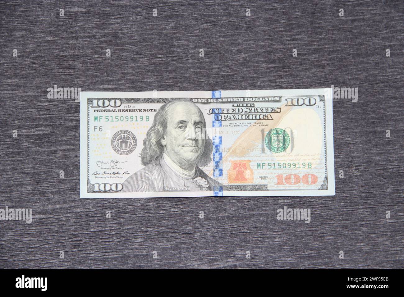 Front side of hundred dollar bill. One hundred dollars on gray background. National currency of USA. United States Money featuring Benjamin Franklin Stock Photo