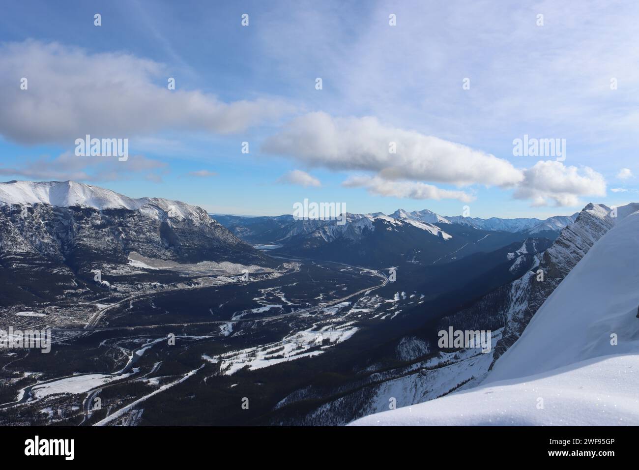 A breathtaking aerial shot of snow-capped mountains, taken from the summit, showcasing the stunning vista Stock Photo