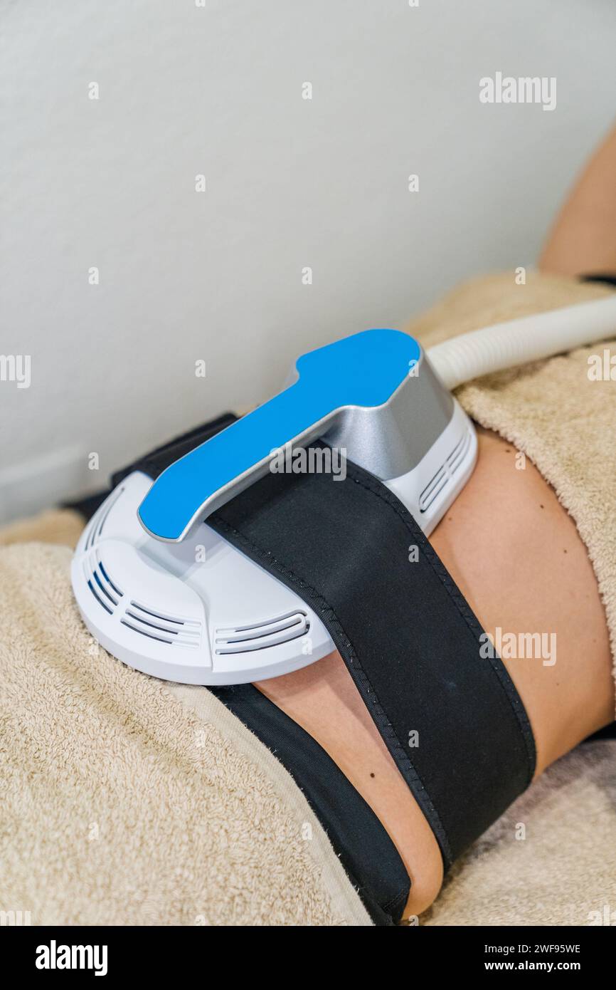 Abdominal electrostimulation treatment for the definition and strengthening of the muscles in the aesthetic center. Stock Photo