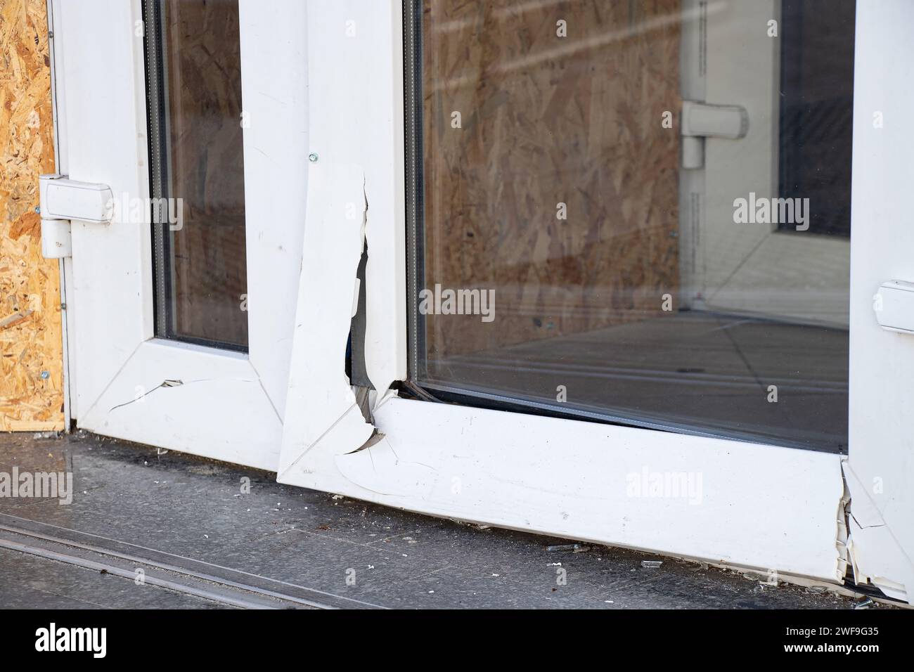 A metal-plastic glass door broken from a blast wave during a missile attack on the Dnieper in Ukraine, war in Ukraine Stock Photo