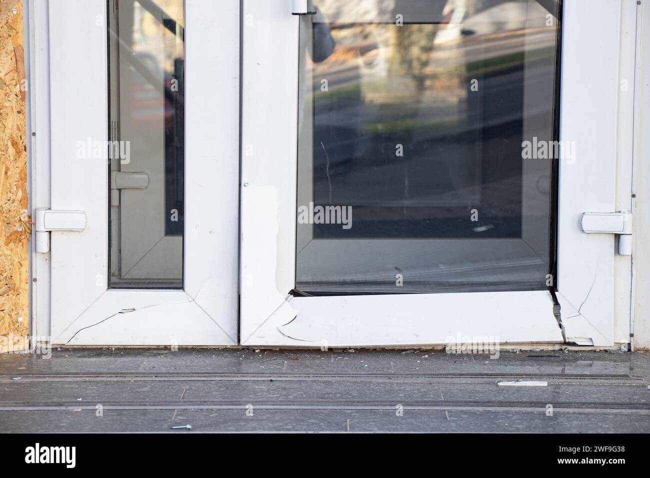 A metal-plastic glass door broken from a blast wave during a missile attack on the Dnieper in Ukraine, war in Ukraine Stock Photo