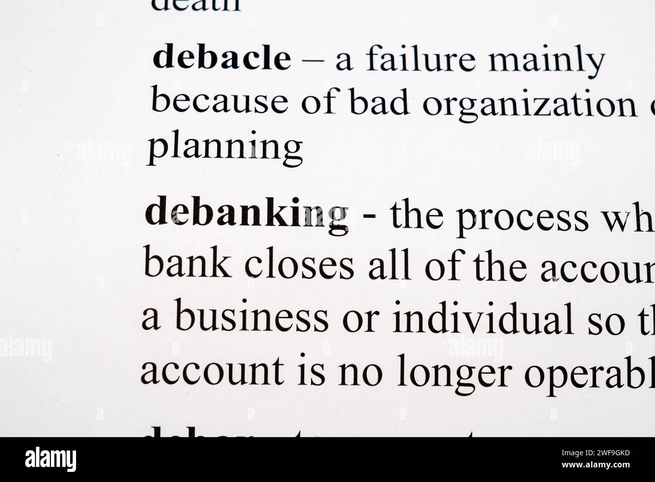 A mock up of a dictionary page with the 2024 buzz word, debanking, with selective focussing Stock Photo