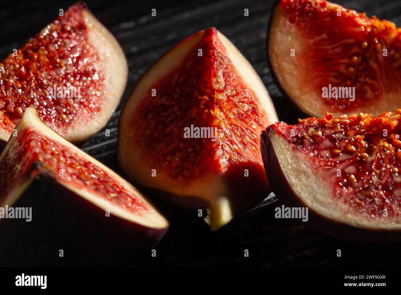 sliced figs on black background Stock Photo