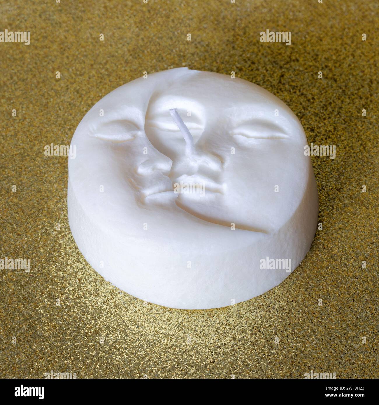 Handmade soy wax candle in moon shape on golden background. Love and ...