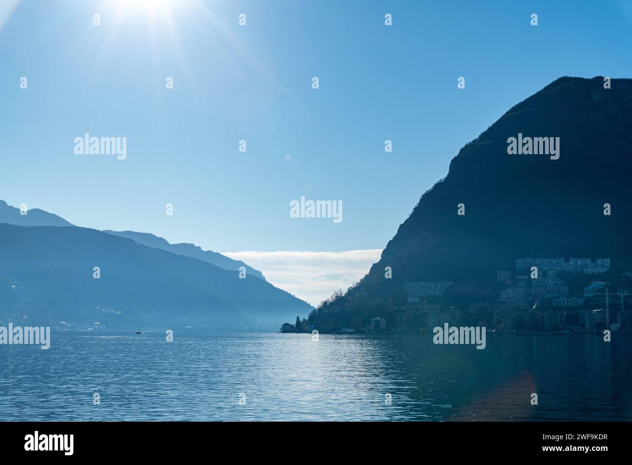A view across Lake Lugano looking at the Alps mountains in Switzerland Stock Photo