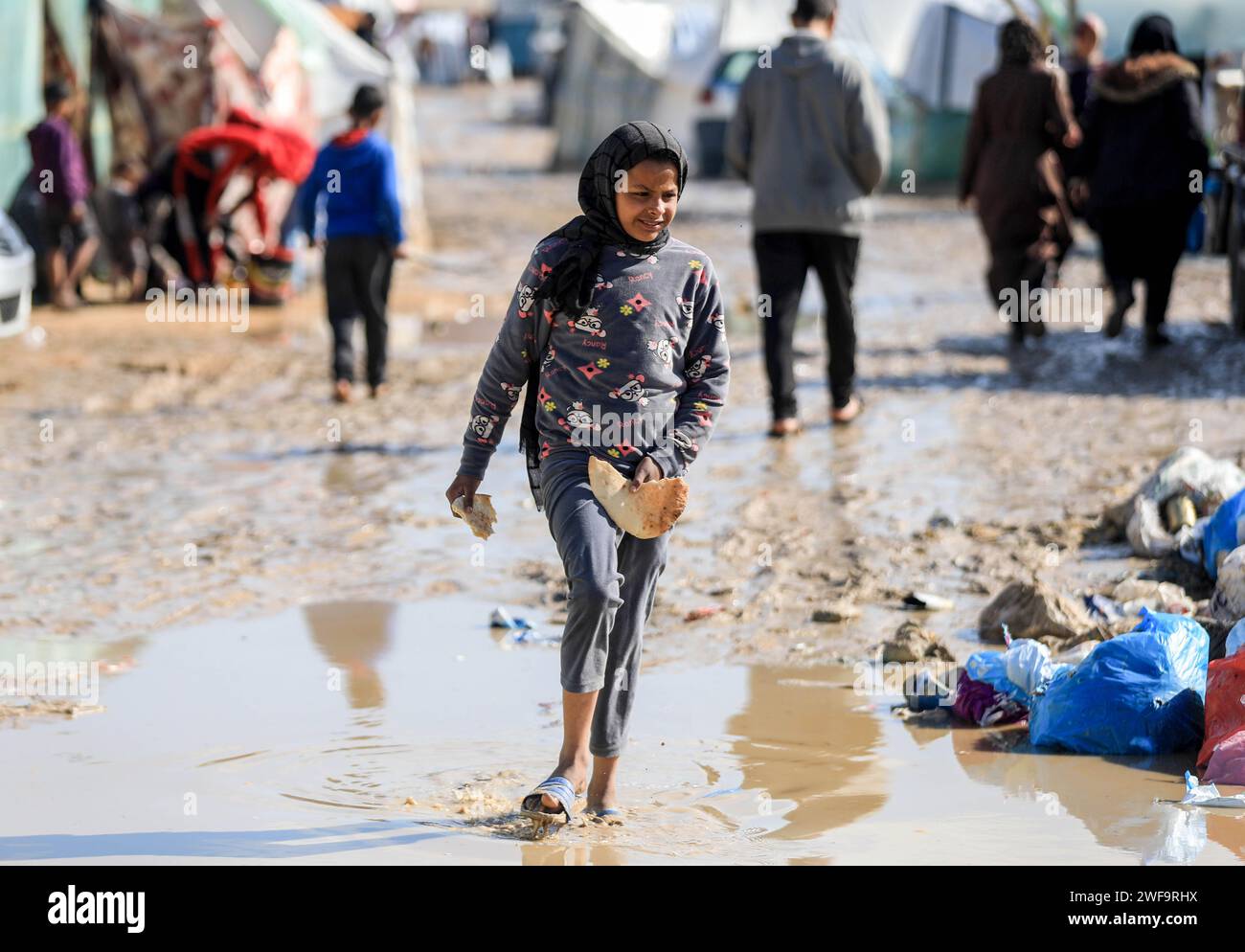 Gaza 28th Jan 2024 A Girl Walks Through Rainwater At A Temporary   Gaza 28th Jan 2024 A Girl Walks Through Rainwater At A Temporary Camp In The Southern Gaza Strip City Of Rafah On Jan 28 2024 The United Nations Office For The Coordination Of Humanitarian Affairs Ocha Warned That Tens Of Thousands Of Displaced People Suffer From Catastrophic Conditions Inside And Outside Shelters Due To Lack Of Food Water Shelter Medical Care And Protection The Absence Of Toilets Increases The Risk Of The Spread Of Disease Especially When Rain Causes Floods It Warned Credit Yasser Qudihxinhuaalamy Live News 2WF9RHX 