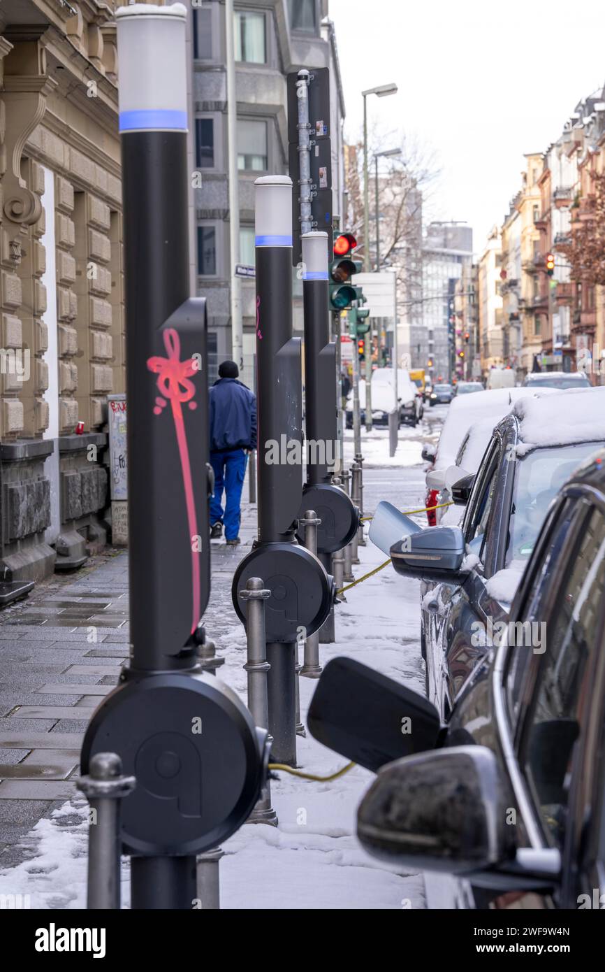 Winter in the city, electric cars charging at charging stations in the city center of Frankfurt, Hesse, Germany Stock Photo