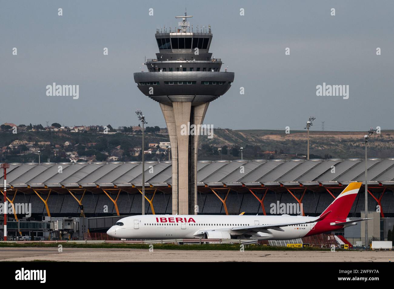 Madrid, Spain. 29th Jan, 2024. An Iberia commercial flight leaves Terminal 4 at Adolfo Suarez Madrid-Barajas Airport passing by the control tower. The President of the Government of Spain, Pedro Sanchez, announced the launch of the expansion of the Adolfo Suarez Madrid-Barajas airport, which will be the largest investment in airport infrastructure in the last decade with 2,400 million euros. Credit: Marcos del Mazo/Alamy Live News Stock Photo